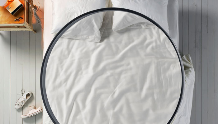 magnifying glass above a bed