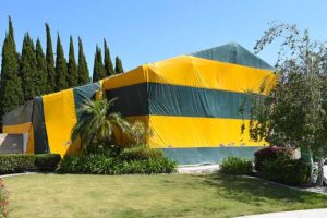 A two story house tented for Fumigation, a method of pest control for termites, that fills the house with gaseous pesticides.