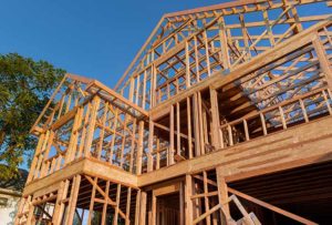 Exterior framing of a new house under construction frame stick abstract a blue sky